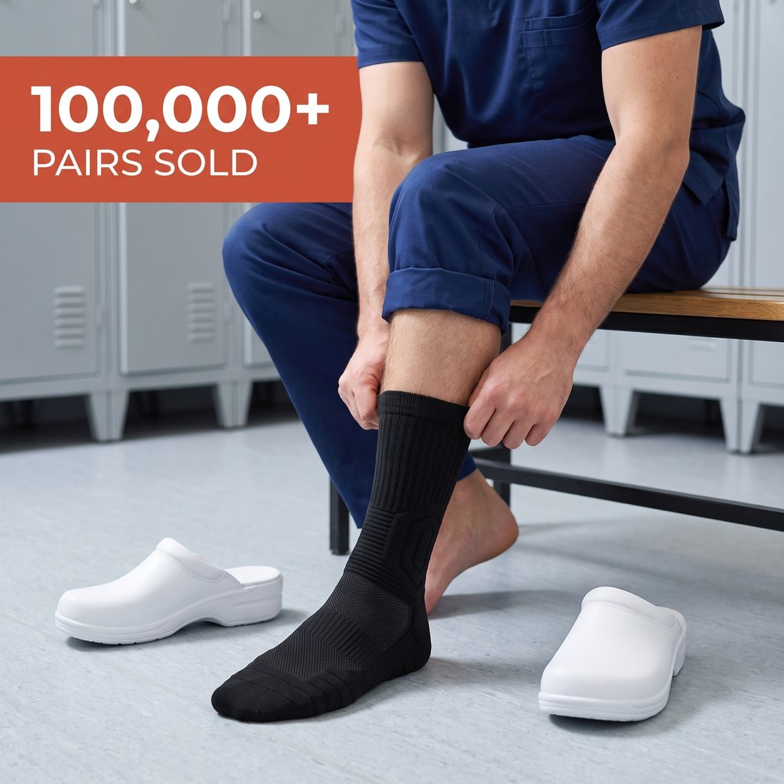 Male nurse on a locker room bench pulling on a black Shift Sock, white clogs beside him, 100,000+ pairs sold.